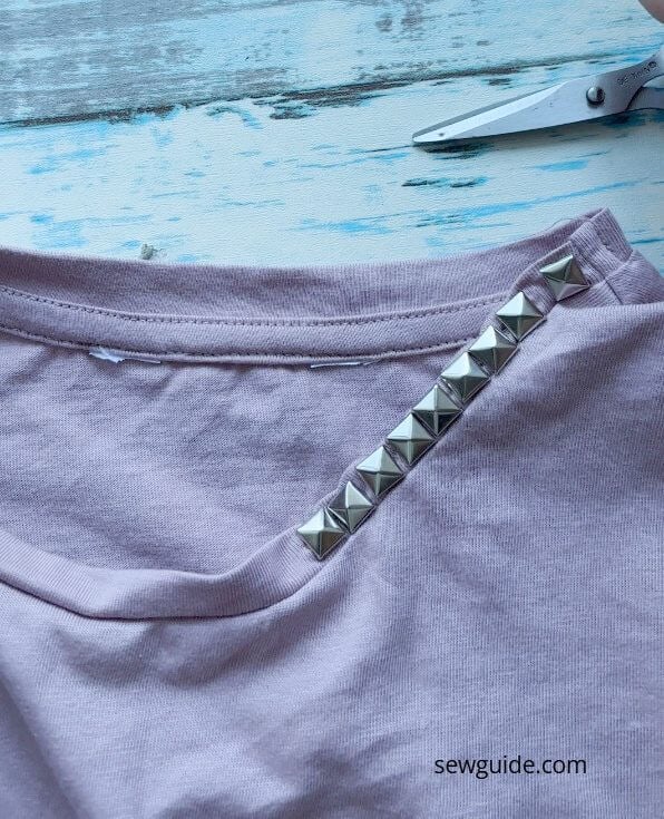 studs attached to the neckline