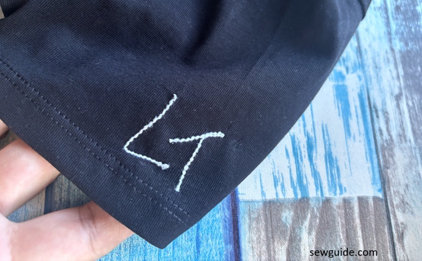 Letters L and T embroidered on a tshirt sleeve