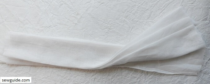 Folded fabric prepared using tie-dye folding techniques