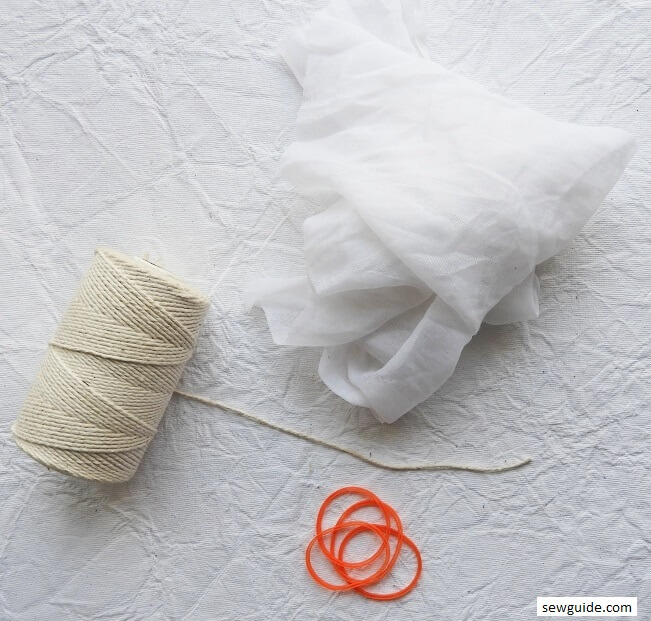 Basic tie-dye supplies including fabric, dye, and tying materials